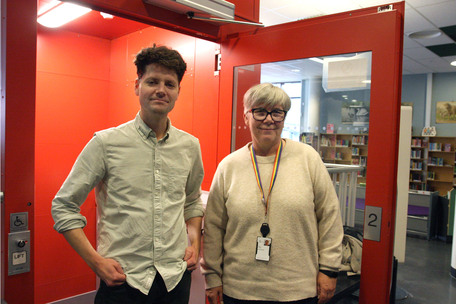 Fredrik Bergseth og Guro Funjem foran løfteplattform med åpen dør i biblioteket