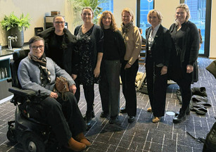 En kvinne i rullestol sammen med seks andre kvinner