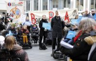 Bent Høie omgitt av demonstranter.