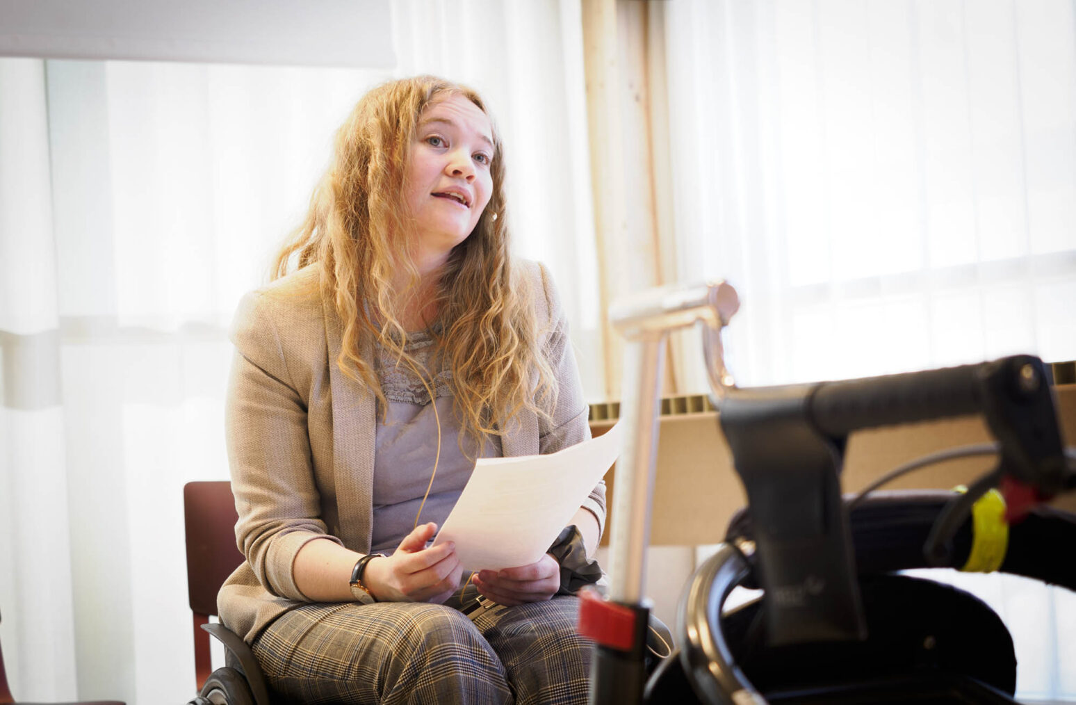 Mia Larsen Sveberg i rullestol, holder et innlegg på en konferanse.