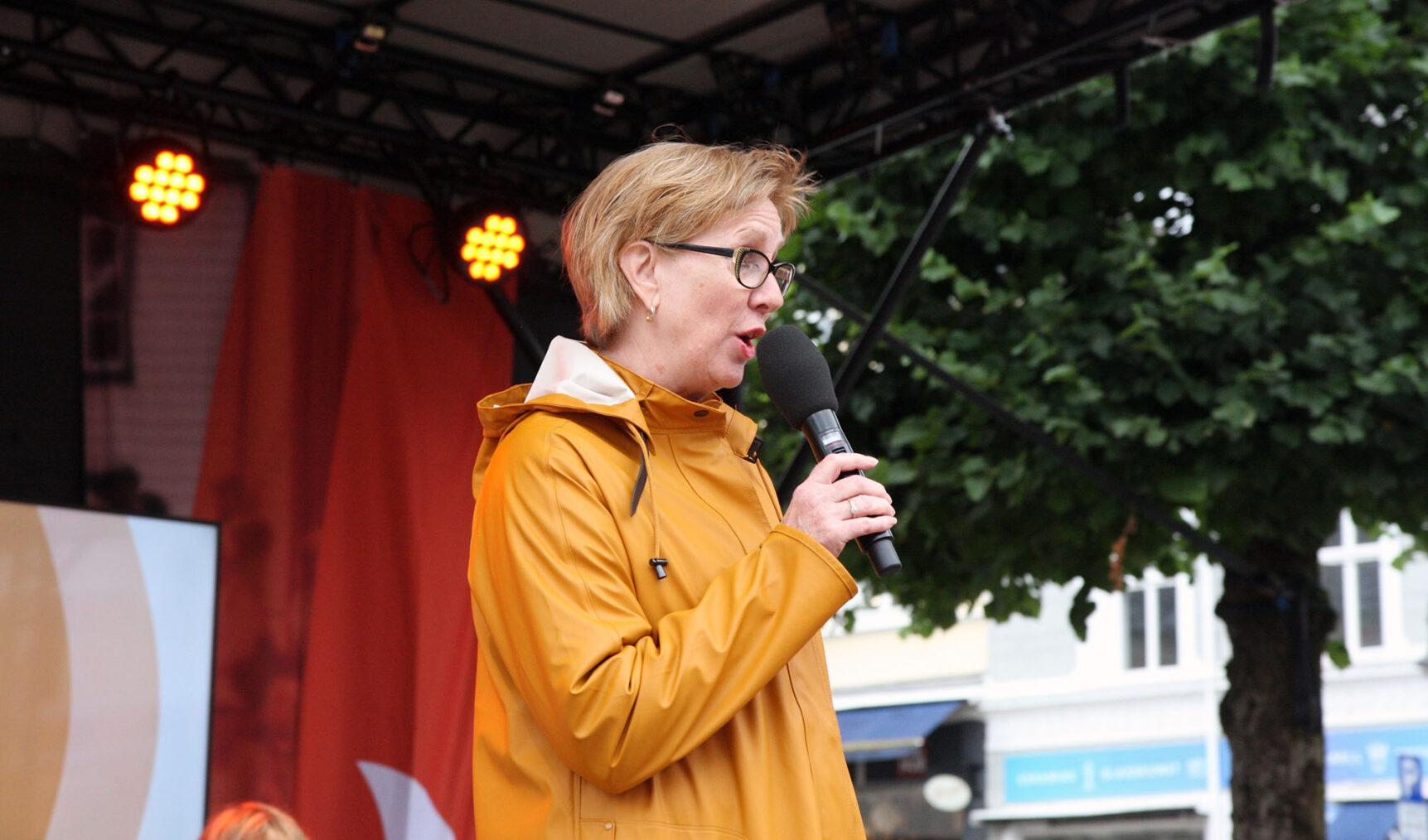 Janne Skei snakker i mikrofon på utescene